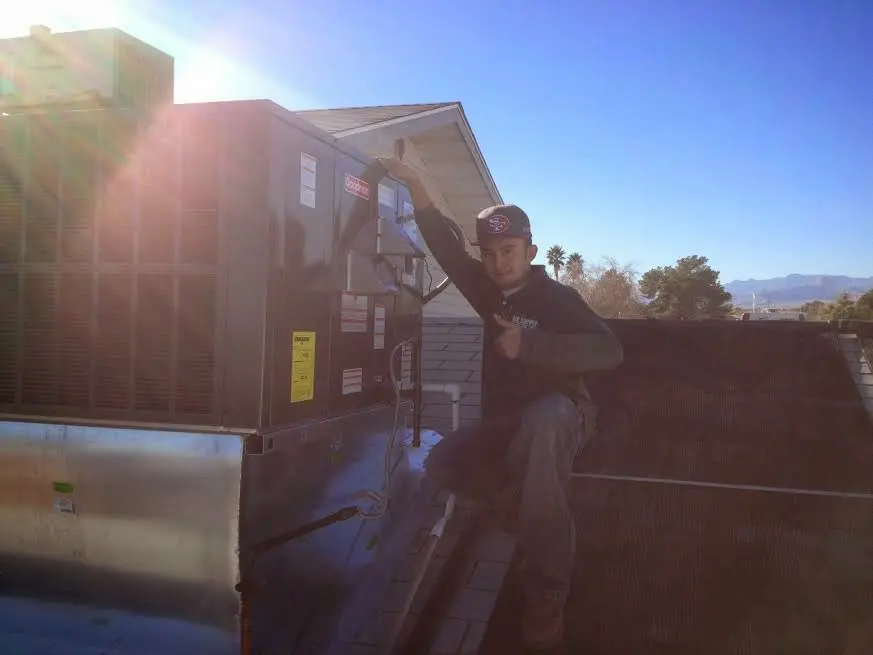 HVAC technician performing HVAC Inspection on a rooftop unit in Rio Linda